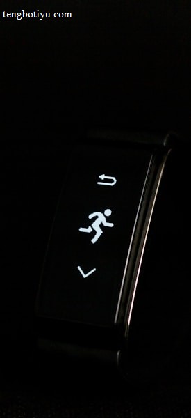 A digital fitness tracker with a black band is displayed against a dark background. The screen features minimalistic white icons for navigation and an exercise mode, including an arrow, a running figure, and a downward-pointing arrow.